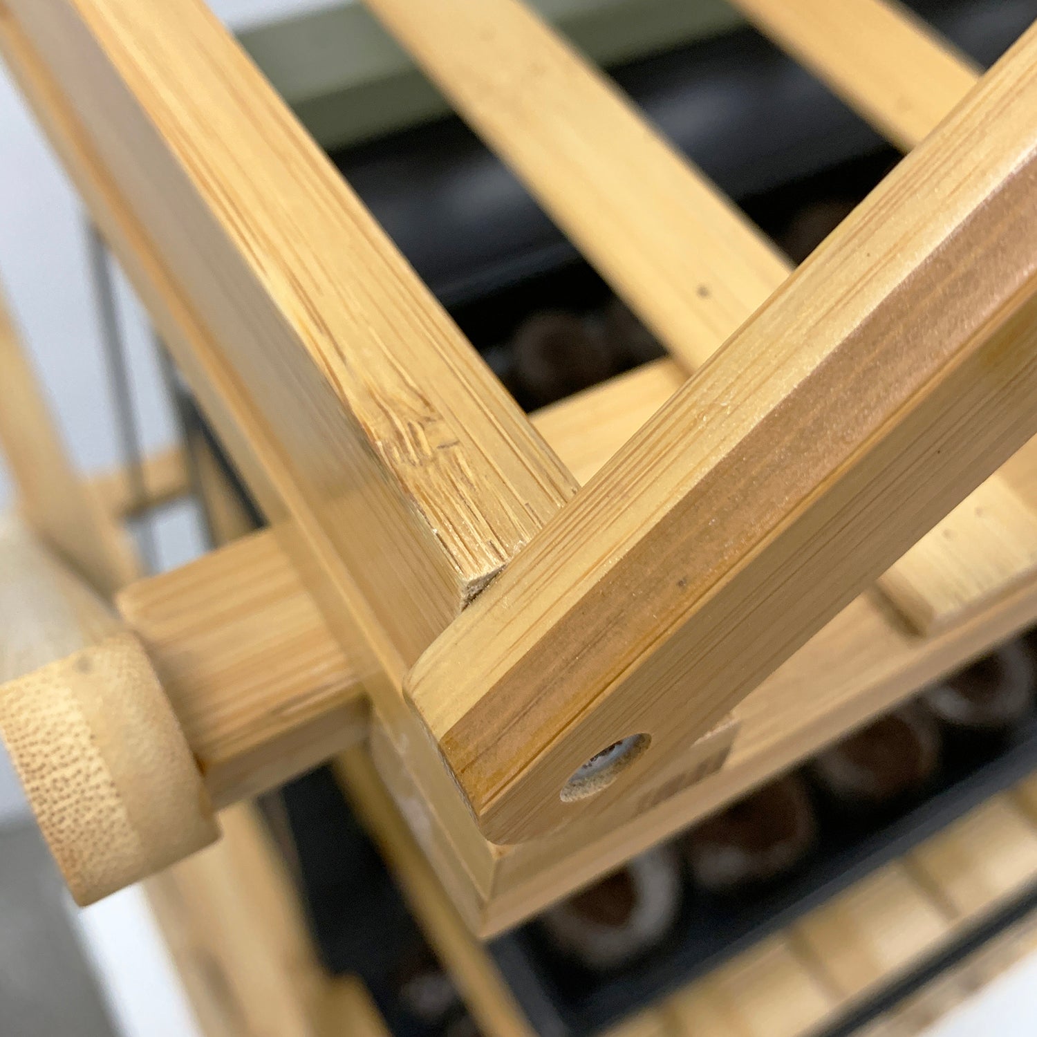 A close-up of a bamboo indoor plant stand with multiple tiers